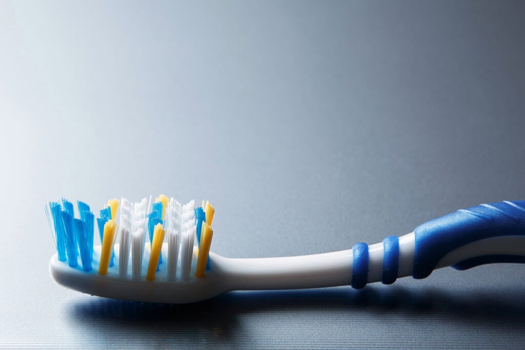scrub with old toothbrush