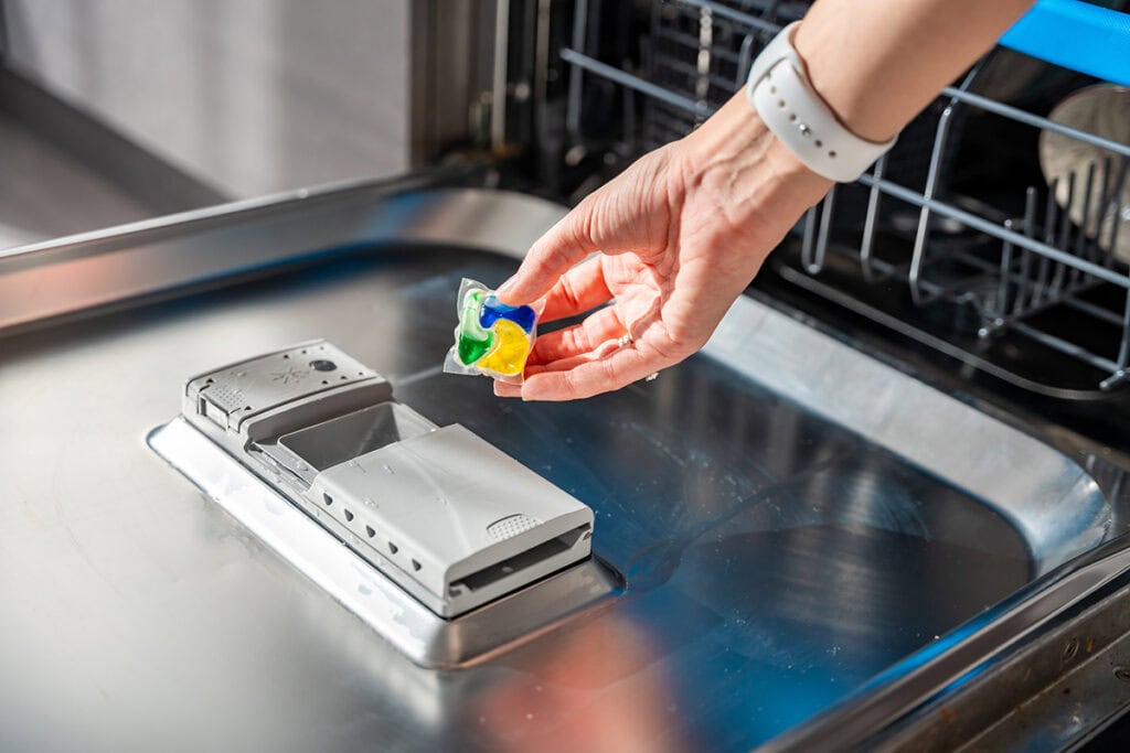 adding dishwasher detergent