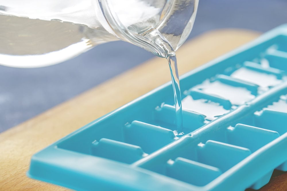pour water into ice tray